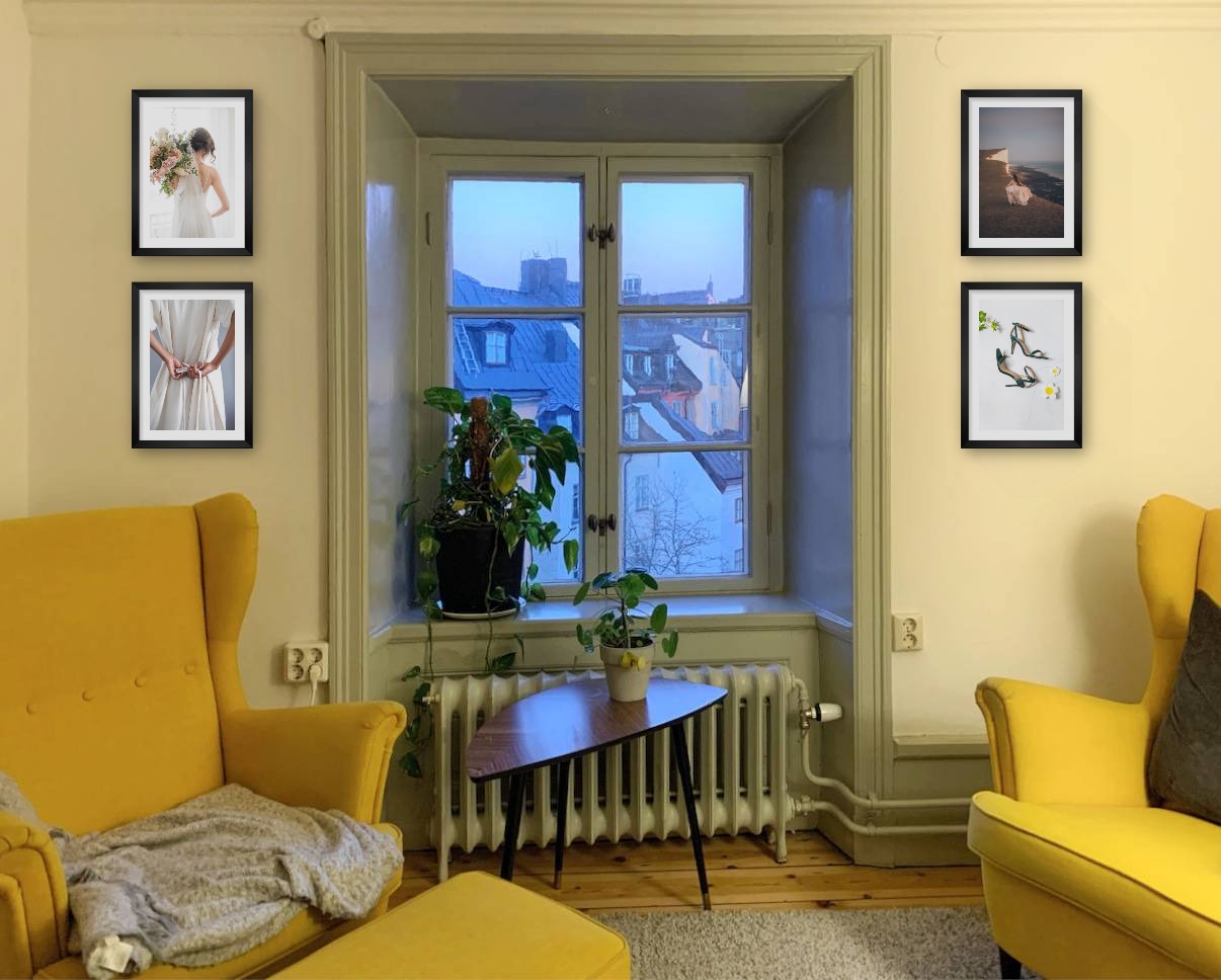 Four black picture frames in the size 21x30 around a window