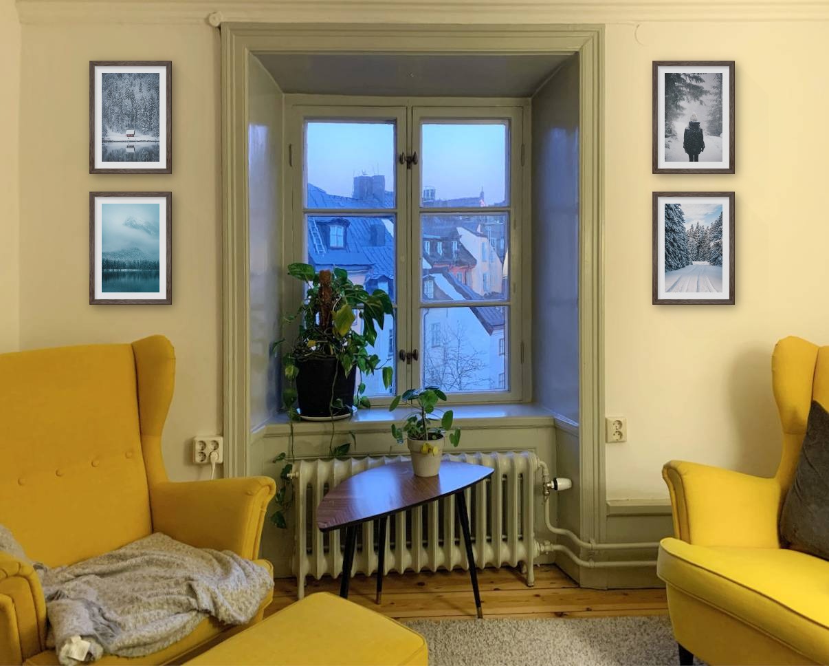 Four picture frames in dark wood in the size 21x30 around a window