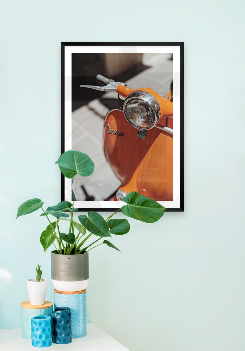 Gallery wall with picture frame in black in size 50x70 with print "Orange vespa"