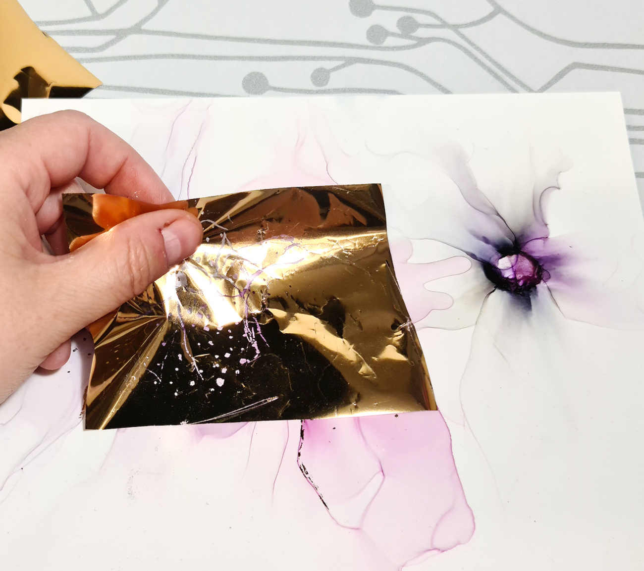 Applying foil on the adhesive glue, © Helena Henriksdotter