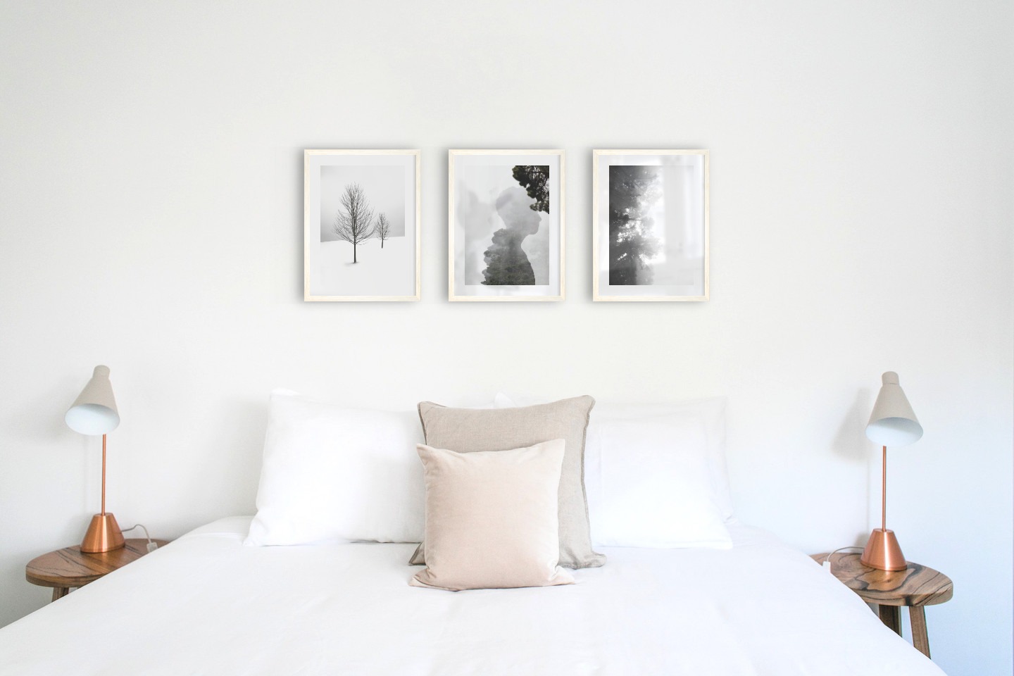 Gallery wall with picture frames in light wood in sizes 30x40 with prints "Trees in the snow", "Silhouette and tree" and "Foggy wooden tops from the side"