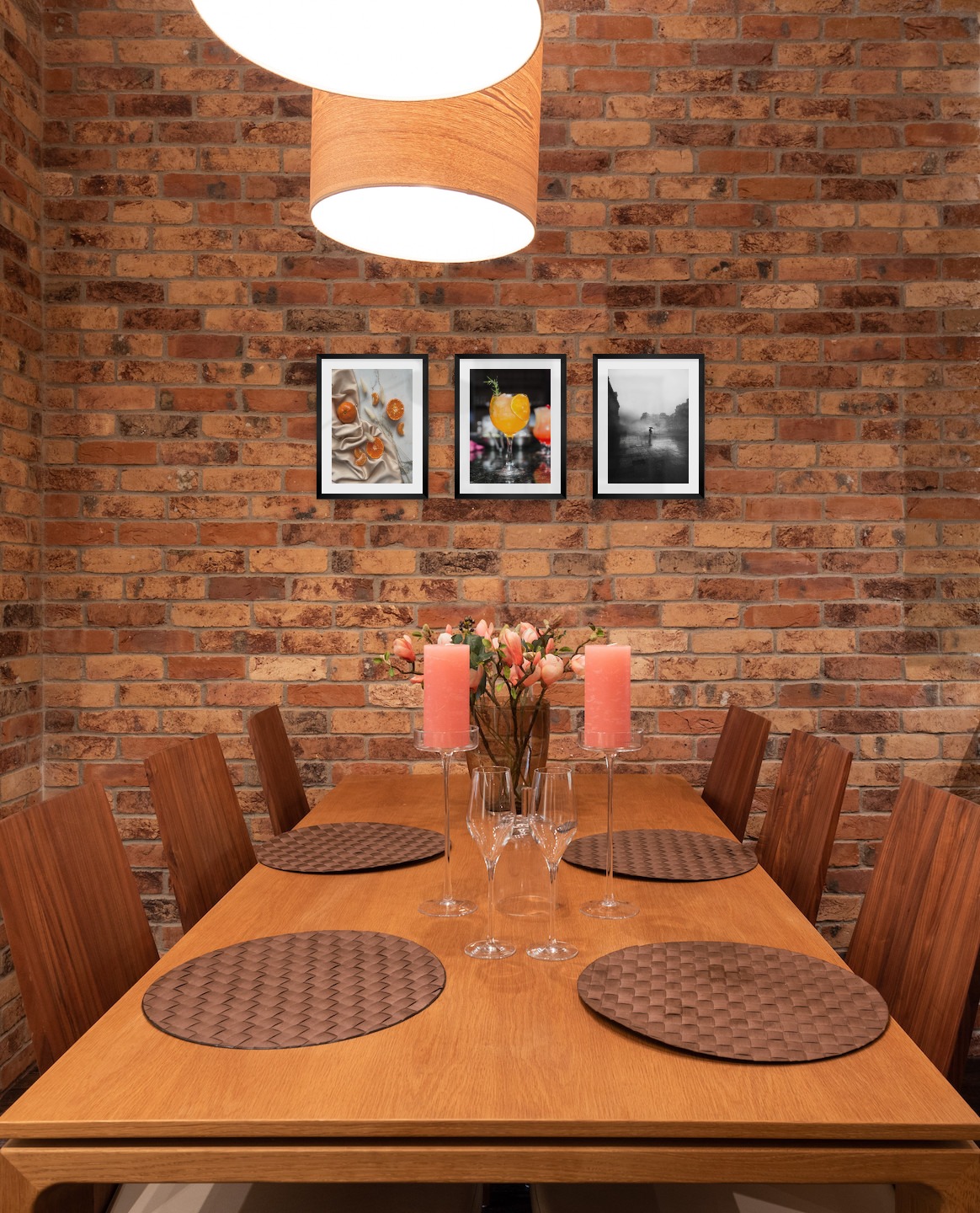 Gallery wall with picture frames in black in sizes 30x40 with prints "Oranges", "High orange drink" and "Rainy city"