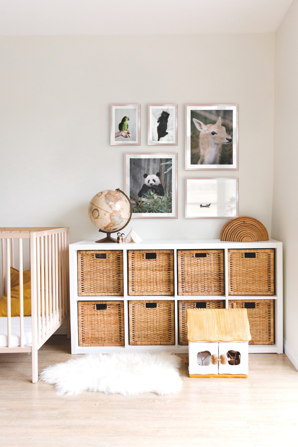 Gallery wall with picture frames in copper in sizes 21x30, 40x50 and 30x40 with prints "Cat in bed", "Green parrot", "Panda", "Deer" and "People in boat"