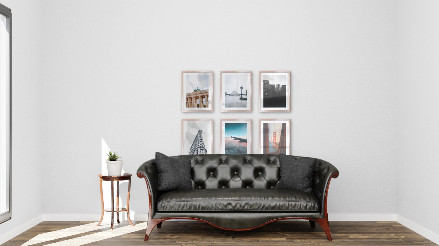 Gallery wall with picture frames in copper in sizes 30x40 with prints "Berlin", "Louvre in Paris", "High buildings", "Gray building", "Above the clouds" and "Golden Gate Bridge"