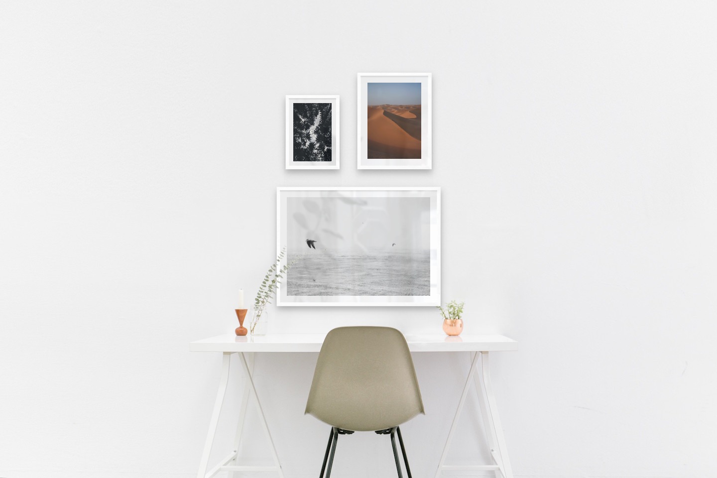 Gallery wall with picture frames in white in sizes 21x30, 30x40 and 50x70 with prints "Wooden tops and birds", "Desert" and "Birds over the sea"