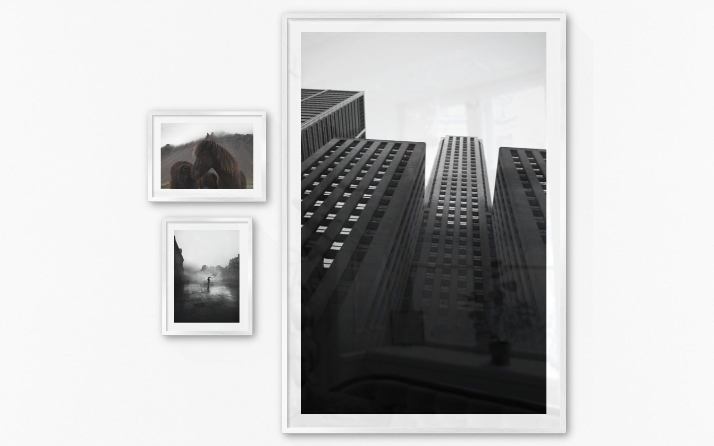 Gallery wall with picture frames in silver in sizes 30x40 and 100x150 with prints "Icelandic horses", "Rainy city" and "High buildings"