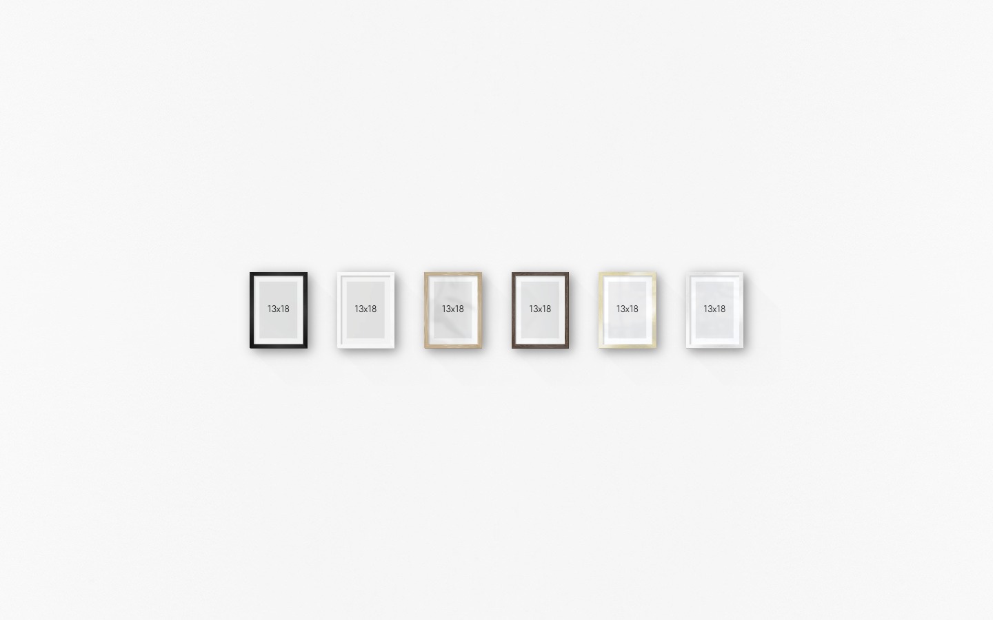 Gallery wall with picture frames in black, white, wood, dark wood, gold and silver in sizes 13x18