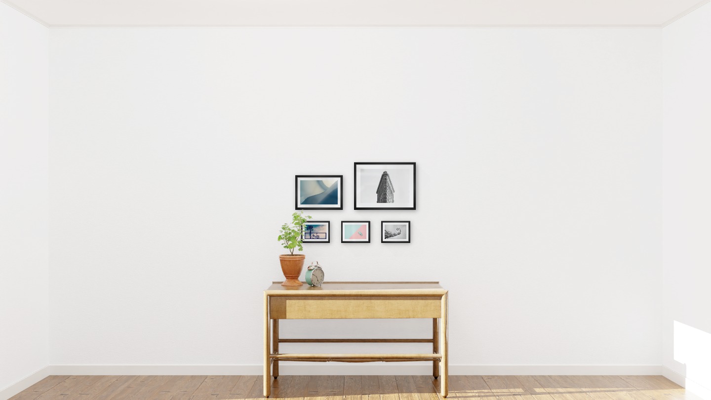 Gallery wall with picture frames in black in sizes 21x30, 30x40 and 13x18 with prints "Blue geometry", "Triangular building", "Bicycle in front of sky", "Blue car and pink" and "Circular stair railing"