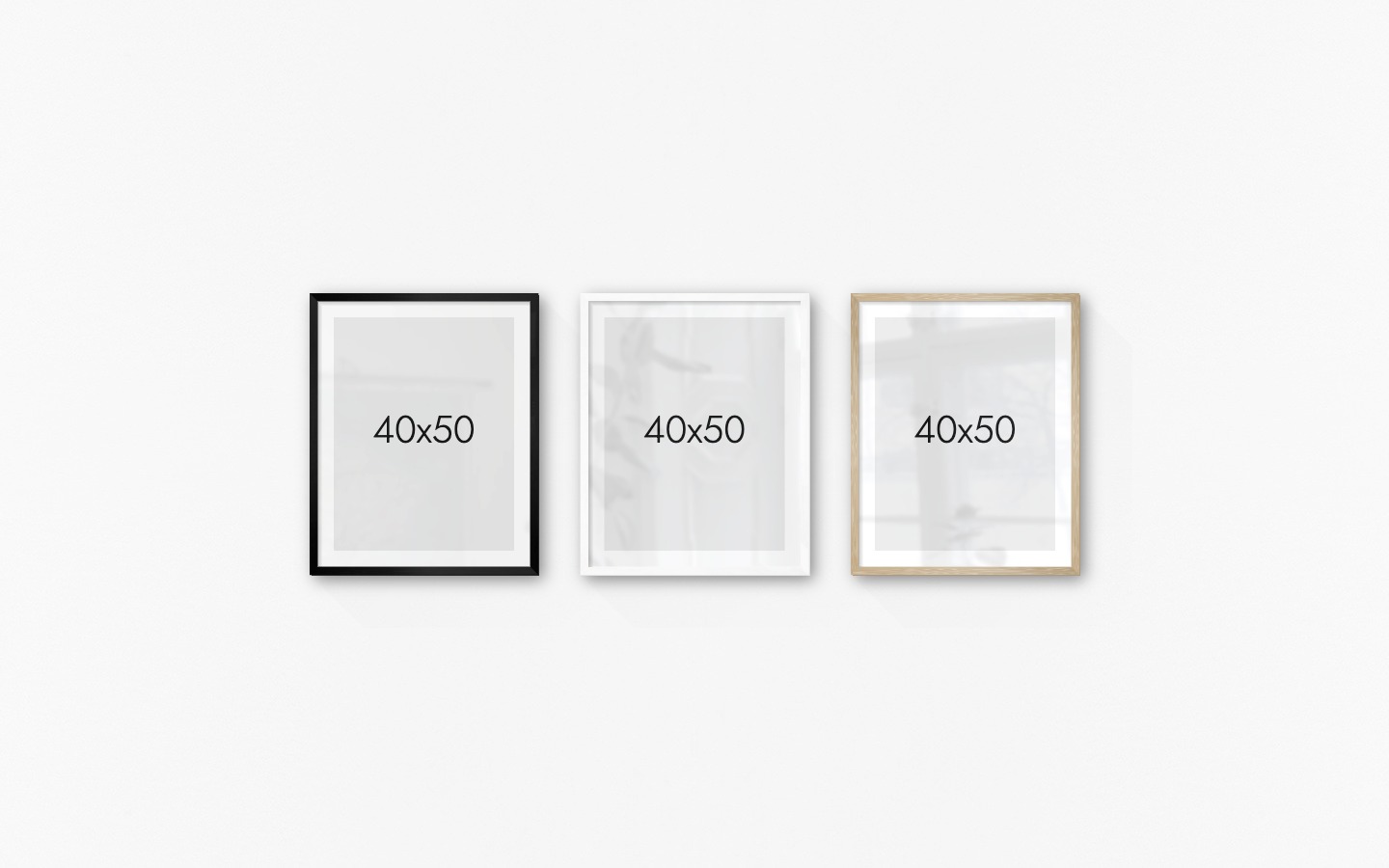 Gallery wall with picture frames in black, white and wood in sizes 40x50