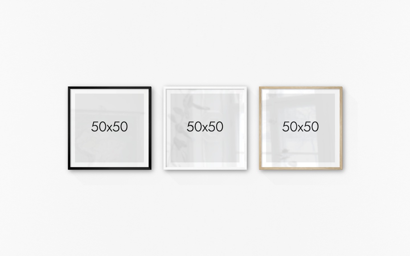 Gallery wall with picture frames in black, white and wood in sizes 50x50