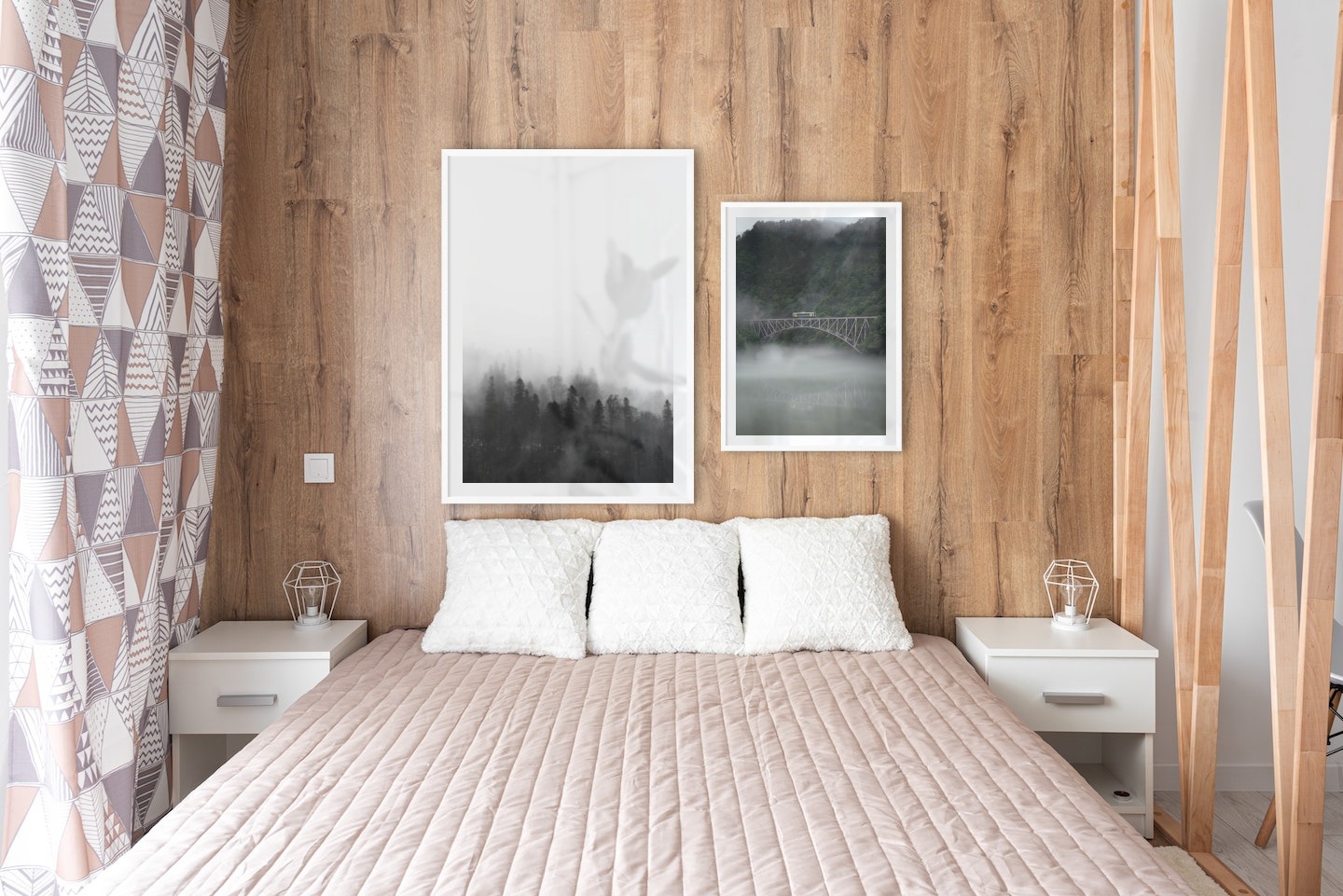 Gallery wall with picture frames in white in sizes 70x100 and 50x70 with prints "Foggy wooden tops" and "Train over bridge"