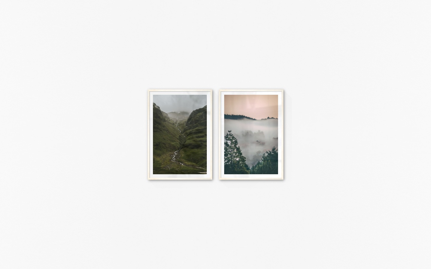 Gallery wall with picture frames in light wood in sizes 70x100 with prints "Stream in valley" and "Wooden tops and orange sky"