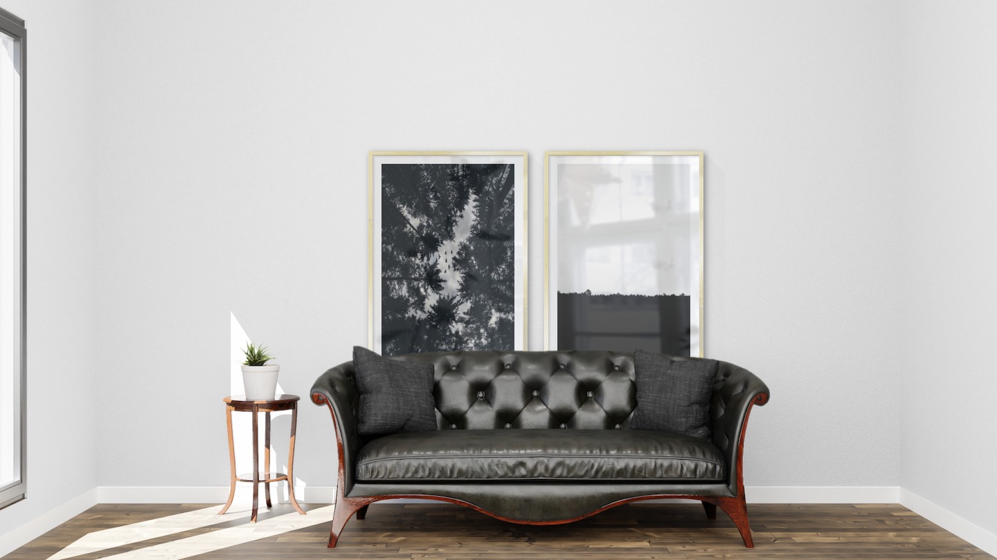 Gallery wall with picture frames in gold in sizes 70x100 with prints "Wooden tops and birds" and "Sky above trees"