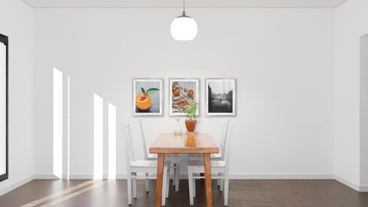 Gallery wall with picture frames in copper in sizes 40x50 with prints "Orange drink", "Oranges" and "Rainy city"