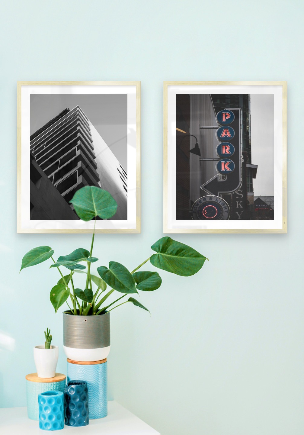 Gallery wall with picture frames in gold in sizes 40x50 with prints "Black and white building" and "Sign "Park""