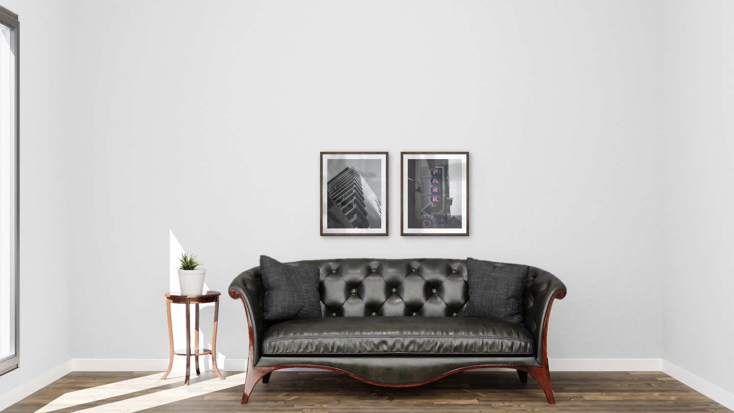 Gallery wall with picture frames in dark wood in sizes 40x50 with prints "Black and white building" and "Sign "Park""