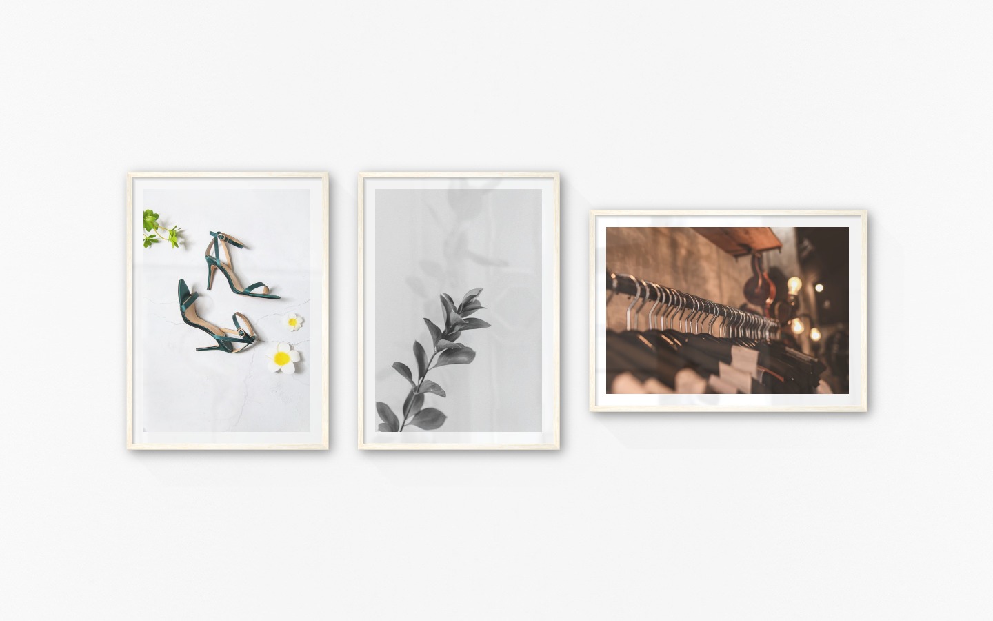 Gallery wall with picture frames in light wood in sizes 50x70 with prints "Heels", "Twig" and "Clothes hangers"