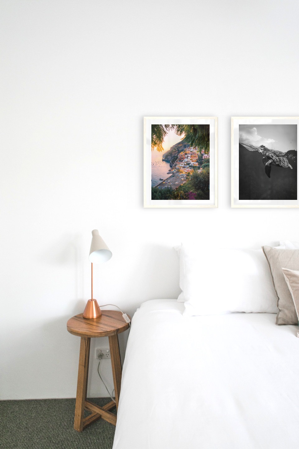 Gallery wall with picture frames in light wood in sizes 40x50 with prints "City by the sea" and "Turtle"