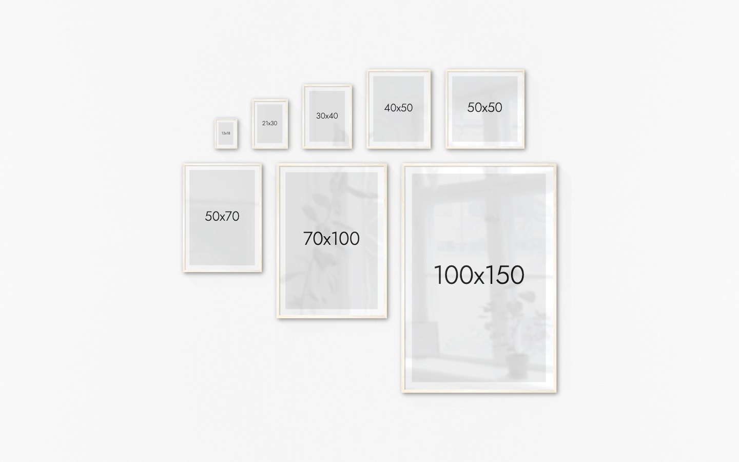 Gallery wall with picture frames in light wood in sizes 13x18, 21x30, 30x40, 40x50, 50x50, 50x70, 70x100 and 100x150