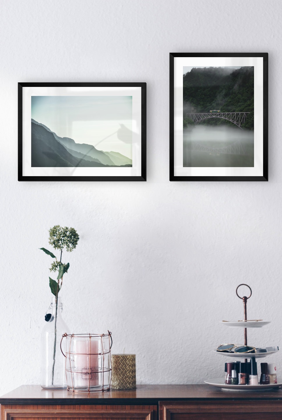 Gallery wall with picture frames in black in sizes 30x40 with prints "Foggy mountain" and "Train over bridge"