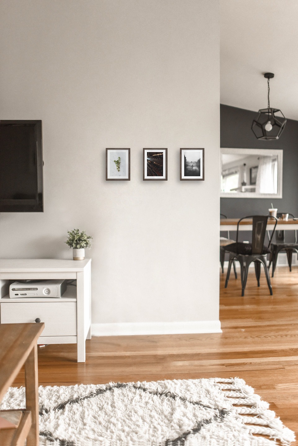 Gallery wall with picture frames in dark wood in sizes 13x18 with prints "Herbs", "Wine storage" and "Rainy city"