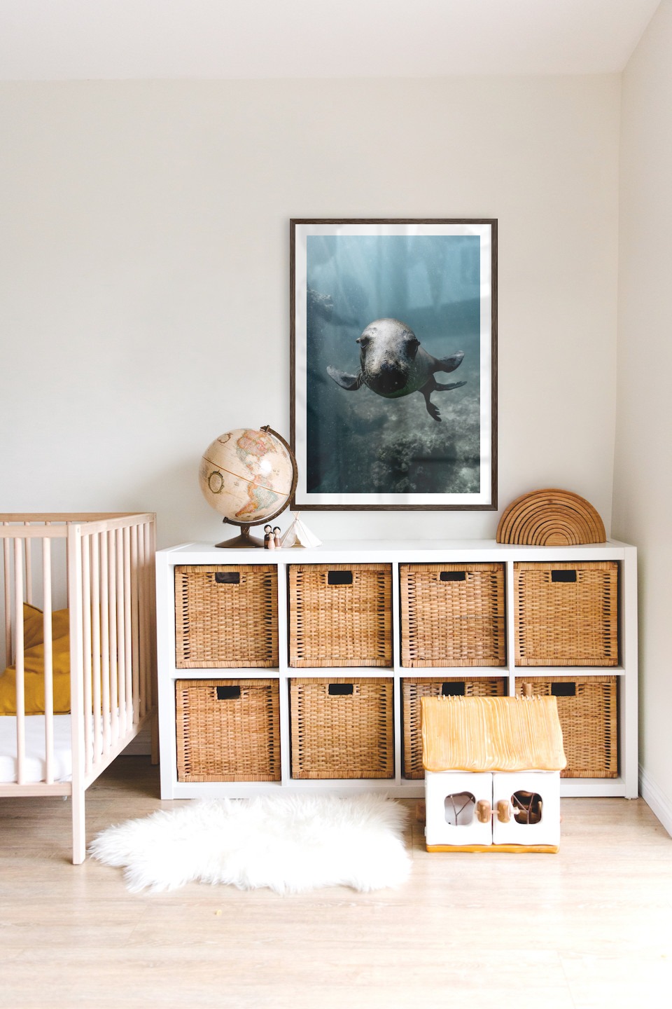 Gallery wall with picture frame in dark wood in size 70x100 with print "Seal in the water"