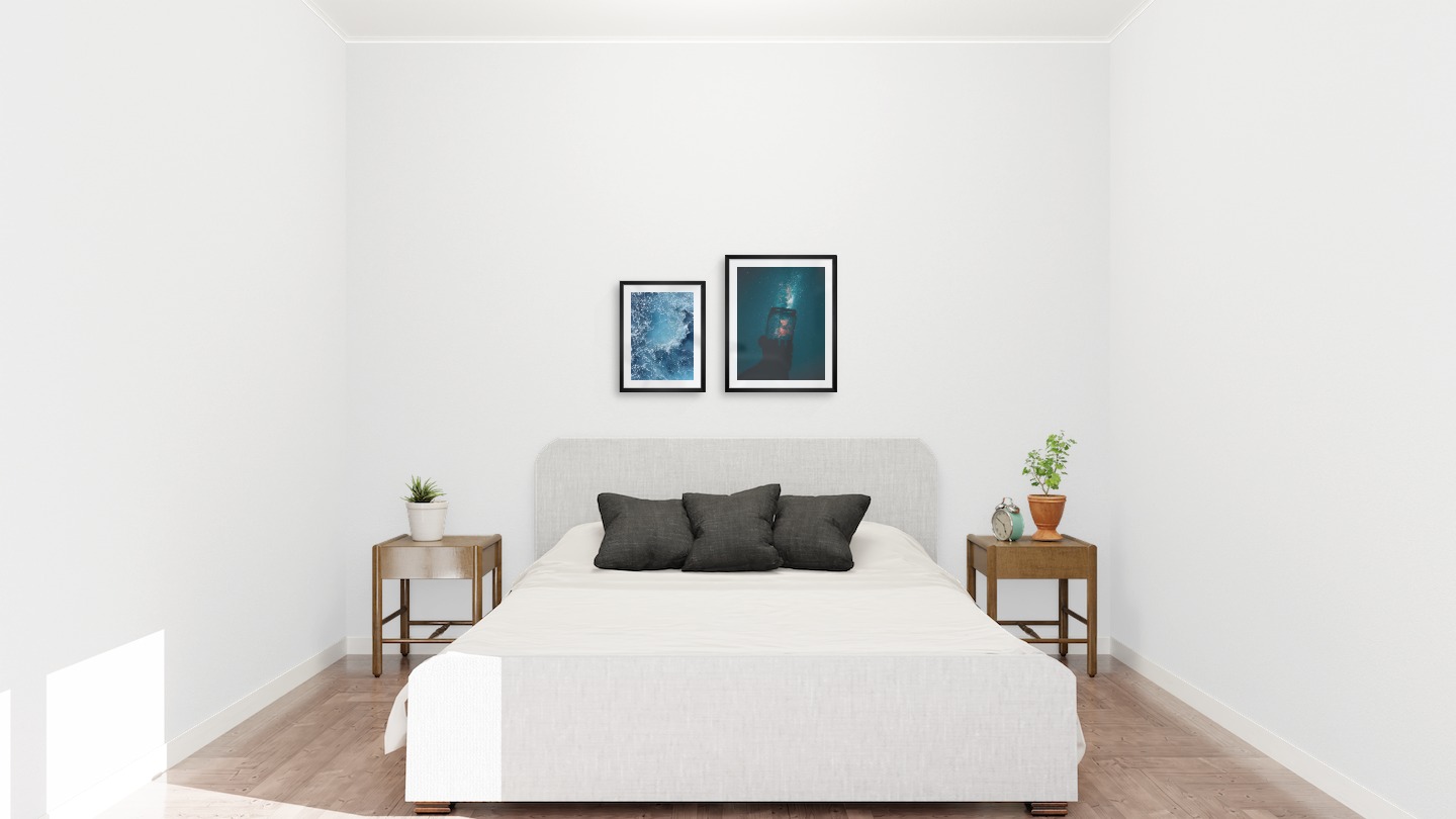 Gallery wall with picture frames in black in sizes 30x40 and 40x50 with prints "Sea from above" and "Jar in front of space"