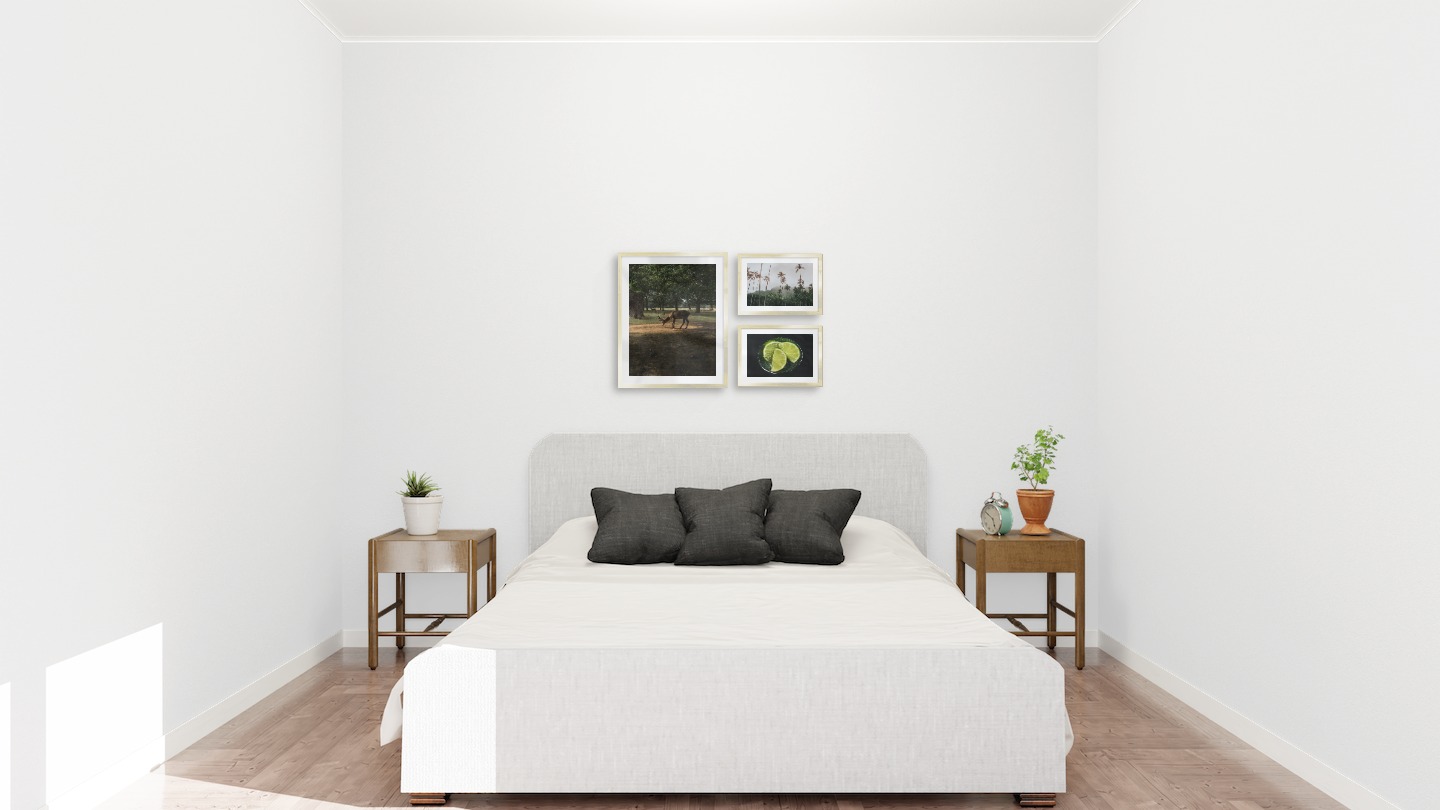Gallery wall with picture frames in gold in sizes 40x50 and 21x30 with prints "Deer in forest", "Palm trees and mountains" and "Lime and glass"