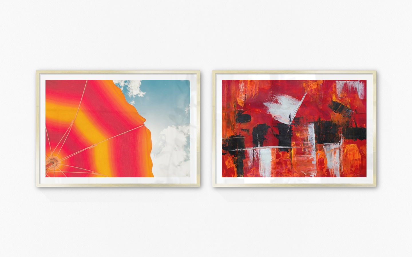 Gallery wall with picture frames in gold in sizes 70x100 with prints "Parasol and sky" and "Abstract art 4"