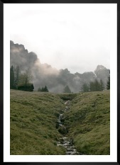 Gallery wall with picture frame in black in size 50x70 with print "Green valley in front of mountains"