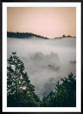 Gallery wall with picture frame in black in size 50x70 with print "Wooden tops and orange sky"