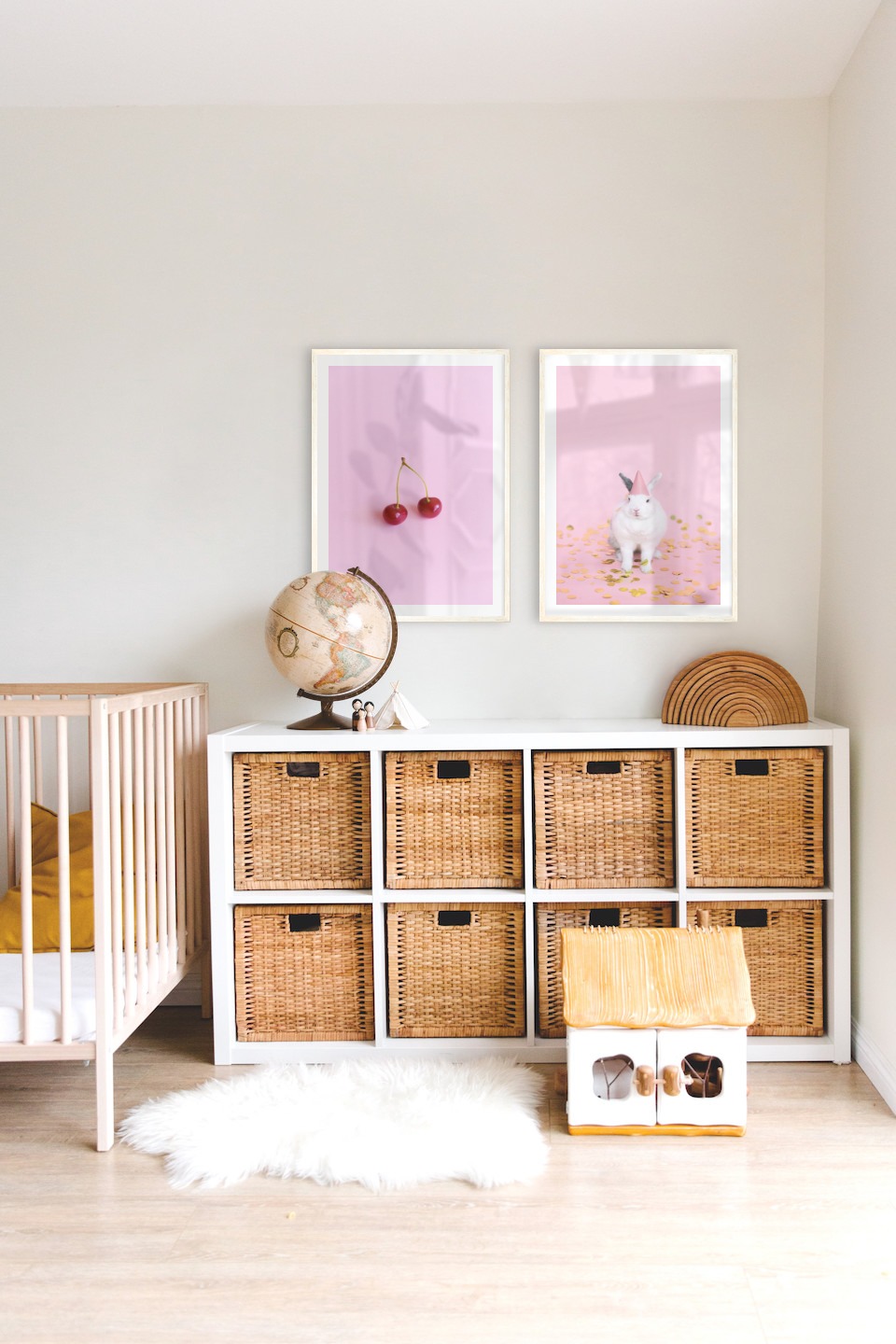 Gallery wall with picture frames in light wood in sizes 50x70 with prints "Cherries and pink" and "Rabbit with party hat"