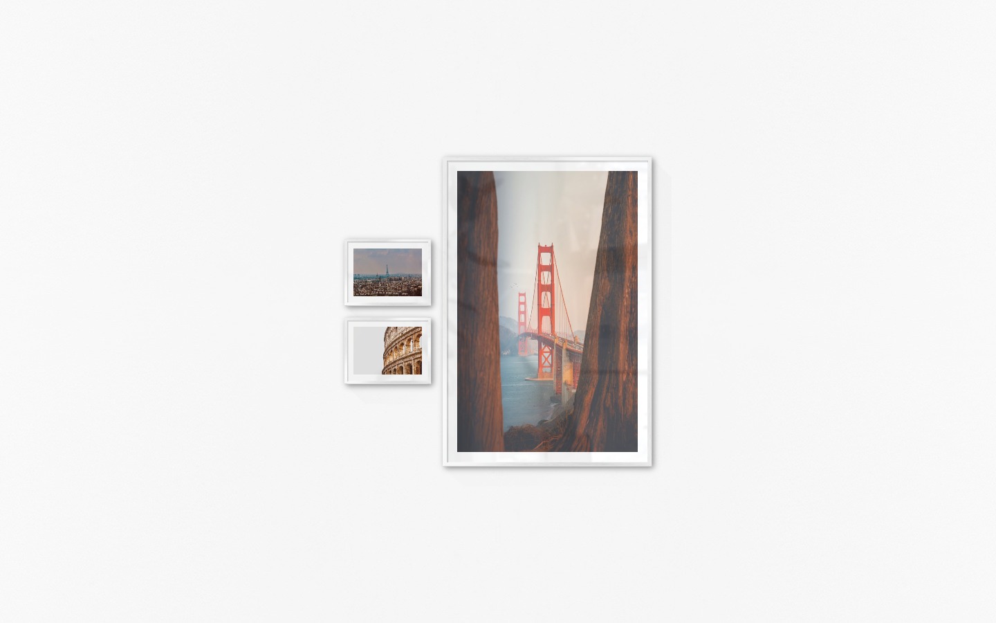 Gallery wall with picture frames in silver in sizes 30x40 and 100x150 with prints "Eifel Tower in Paris", "Colosseum and Rome" and "Golden Gate Bridge"