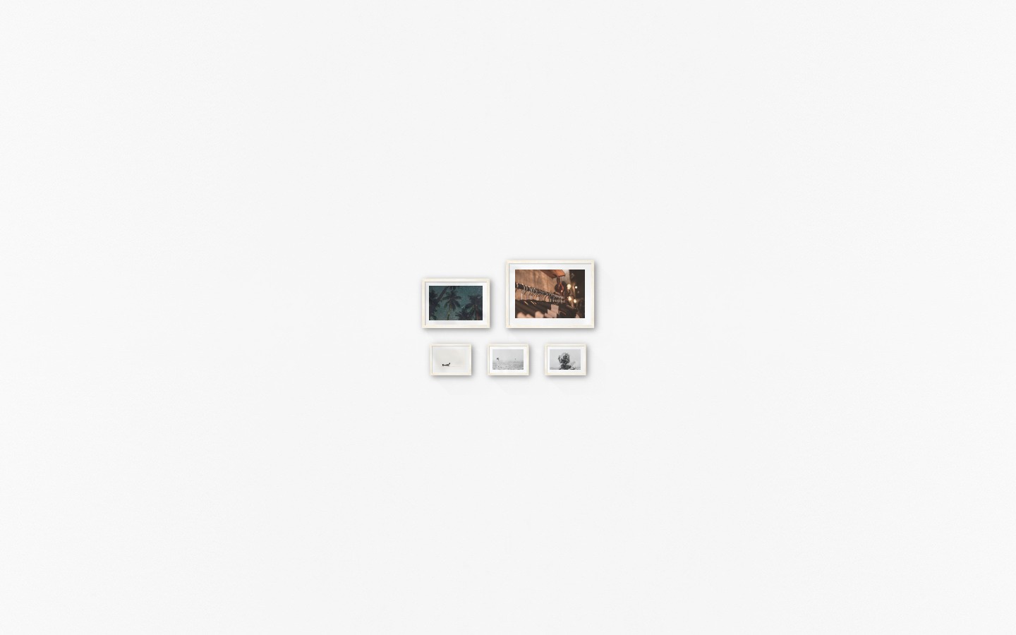 Gallery wall with picture frames in light wood in sizes 21x30, 30x40 and 13x18 with prints "Palm trees and night sky", "Clothes hangers", "People in boat", "Birds over the sea" and "Trees and silhouette"