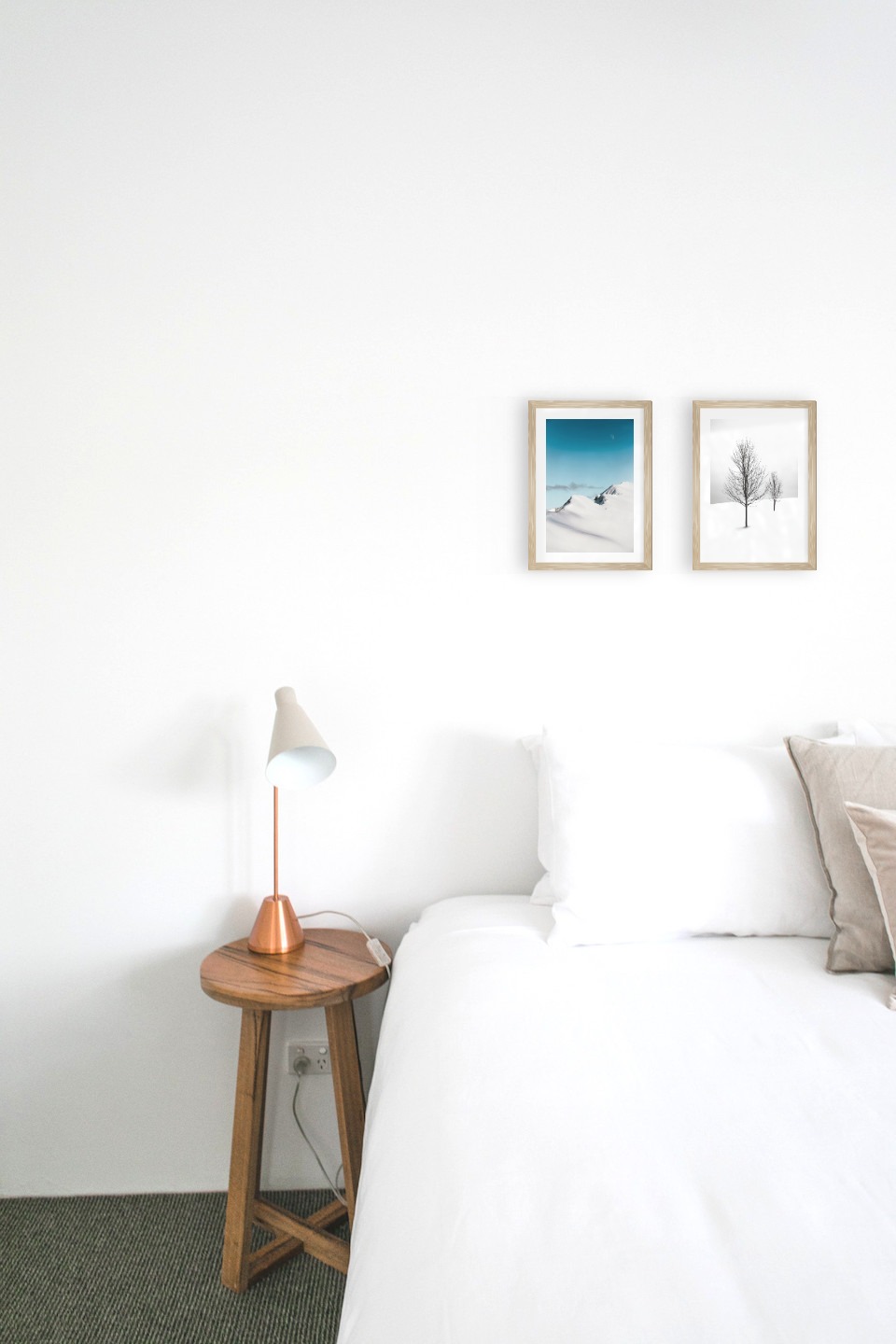 Gallery wall with picture frames in wood in sizes 21x30 with prints "Snowy mountain peaks" and "Trees in the snow"