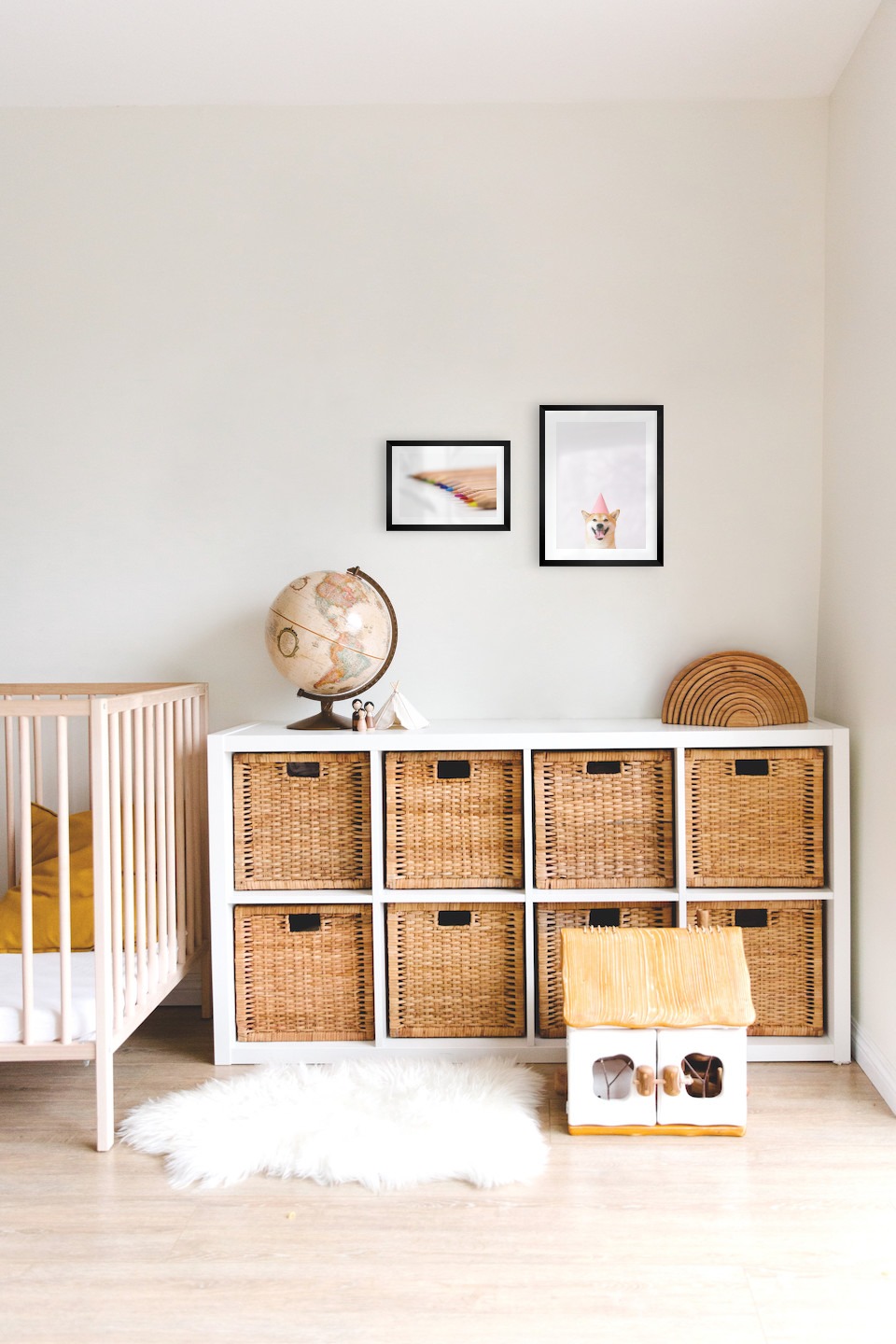 Gallery wall with picture frames in black in sizes 21x30 and 30x40 with prints "Pencils in different colors" and "Dog with pink hat"