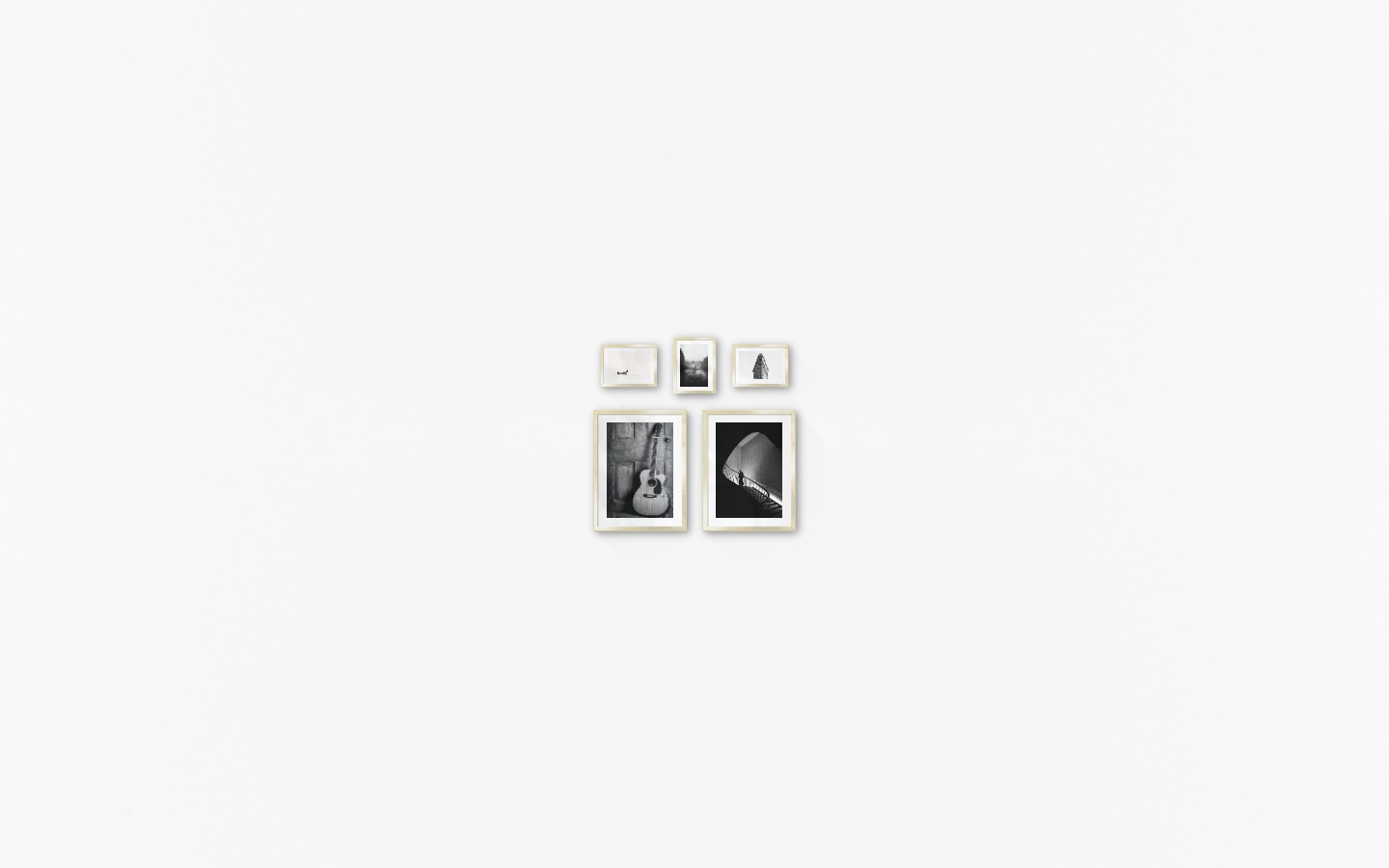 Gallery wall with picture frames in gold in sizes 30x40 and 13x18 with prints "Guitar", "Staircase", "People in boat", "Rainy city" and "Triangular building"