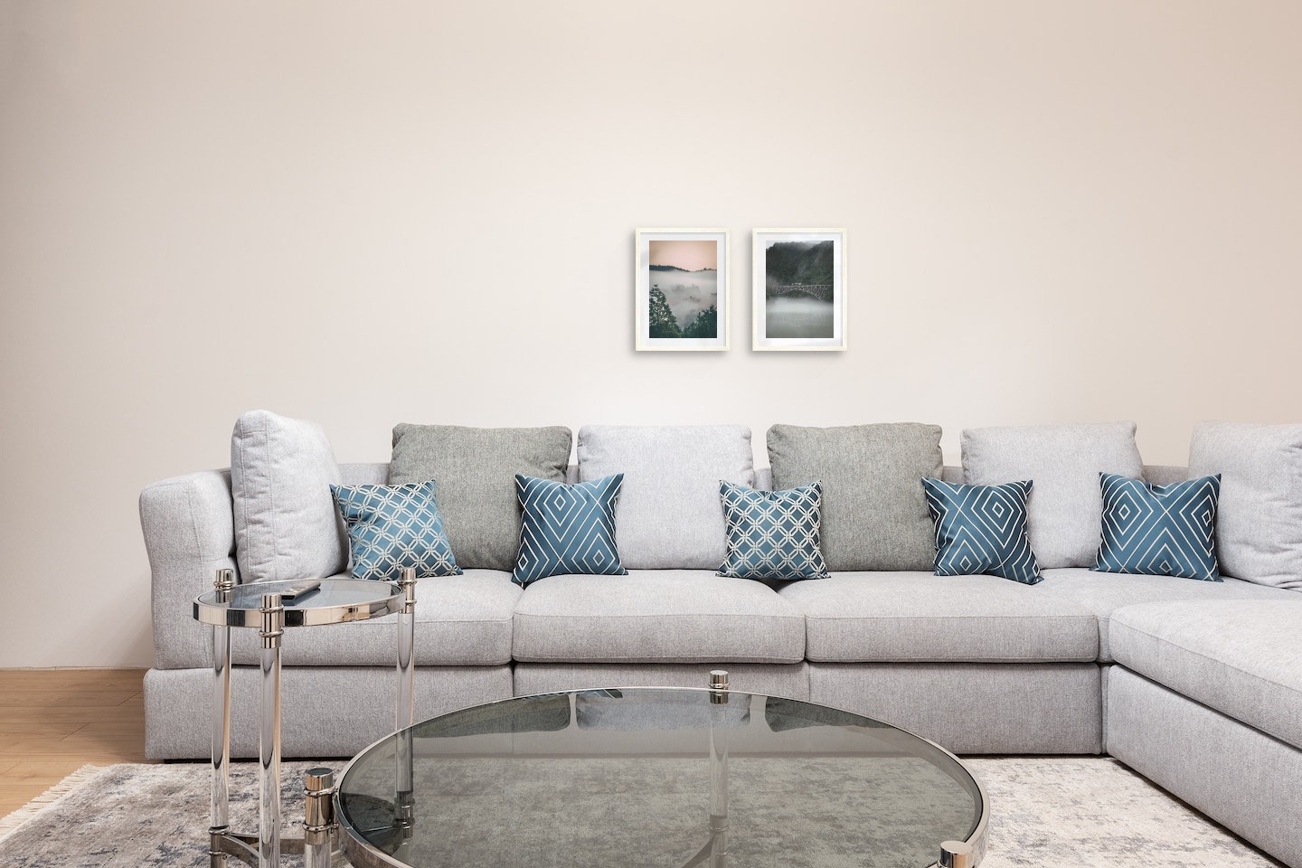 Gallery wall with picture frames in light wood in sizes 30x40 with prints "Wooden tops and orange sky" and "Train over bridge"