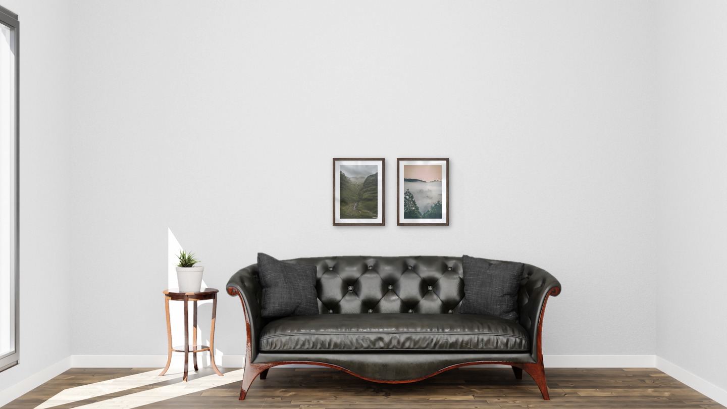 Gallery wall with picture frames in dark wood in sizes 30x40 with prints "Stream in valley" and "Wooden tops and orange sky"