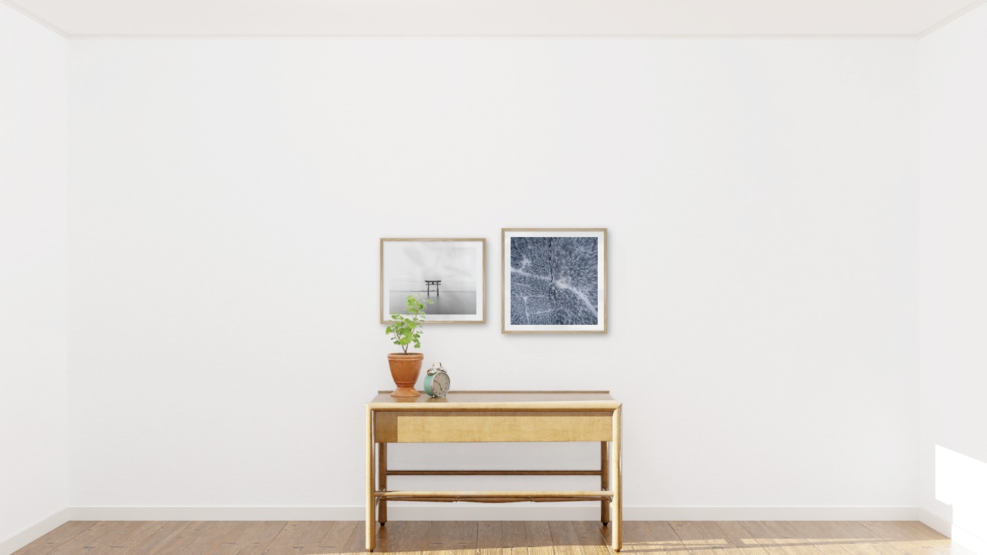 Gallery wall with picture frames in wood in sizes 40x50 and 50x50 with prints "Pillars in the water" and "Snowy treetops"