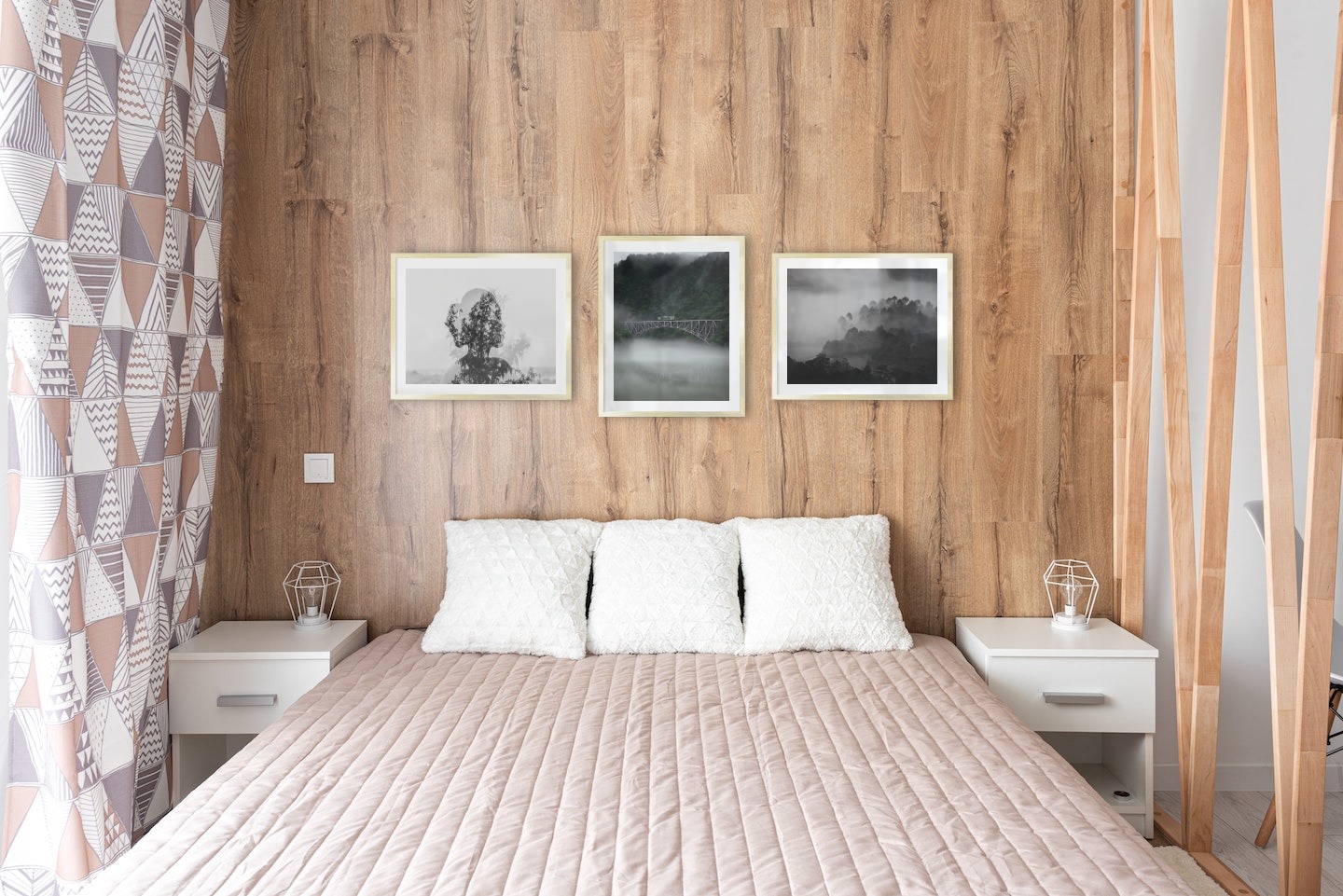 Gallery wall with picture frames in gold in sizes 40x50 with prints "Trees and silhouette", "Train over bridge" and "Foggy wooden tops"