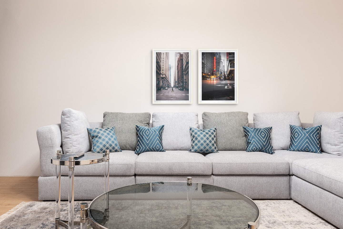 Gallery wall with picture frames in light wood in sizes 50x70 with prints "Man walking across the street" and "Busy city center"