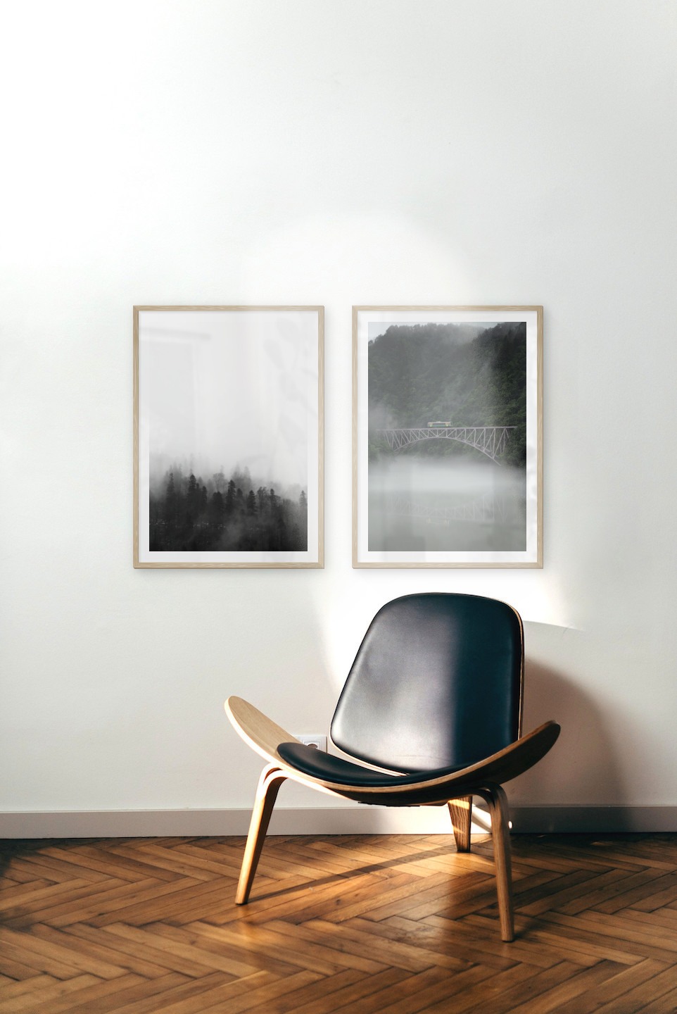 Gallery wall with picture frames in wood in sizes 50x70 with prints "Foggy wooden tops" and "Train over bridge"