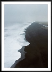 Gallery wall with picture frame in black in size 50x70 with print "Black beach"